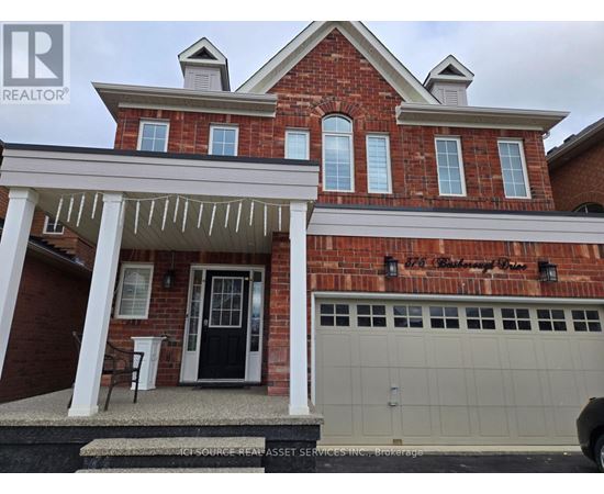 A brick house with a black door and a white garage door.