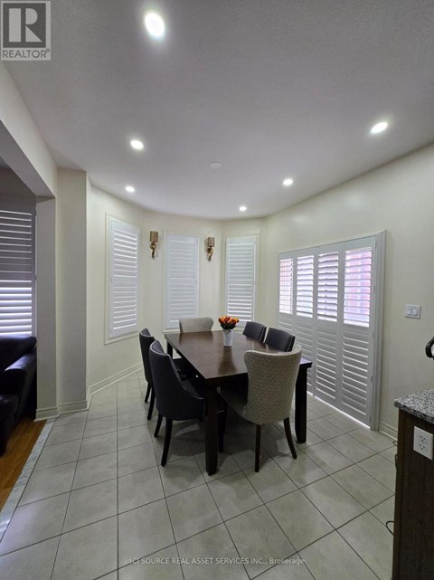 A dining room with a table set for six.