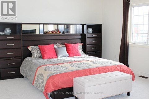 A bedroom with a bed, nightstand, and a bench.