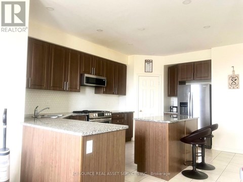 A kitchen with brown cabinets and a white countertop.