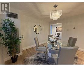 A dining room with a glass table and chairs.