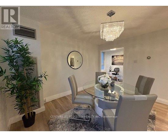 A dining room with a glass table and chairs.