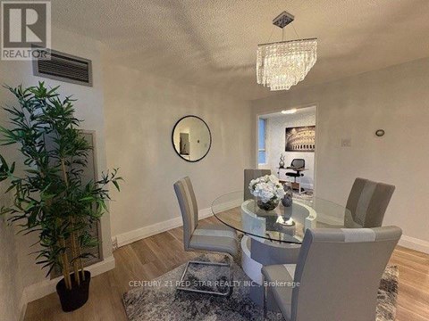 A dining room with a glass table and chairs.
