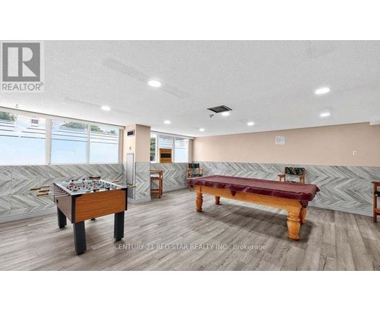 A room with a pool table and a foosball table.