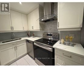 A kitchen with white cabinets and a black stove top oven.