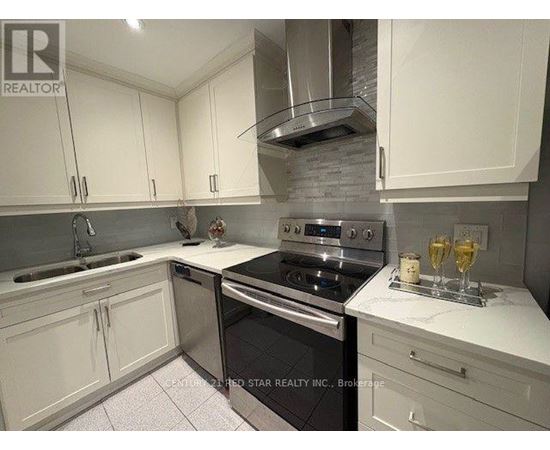 A kitchen with white cabinets and a black stove top oven.