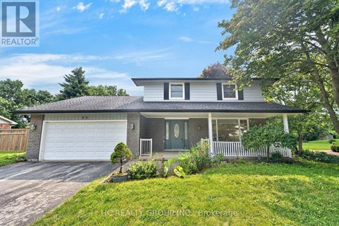 A house with a white garage door and a grey roof.