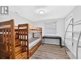 A bedroom with bunk beds and a desk.