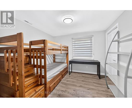 A bedroom with bunk beds and a desk.
