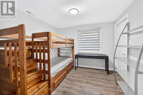 A bedroom with bunk beds and a desk.