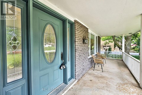 A blue door with a glass window and a mirror above it.
