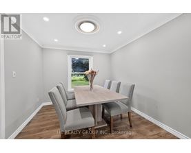 A dining room with a table and chairs.