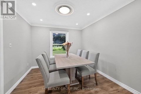 A dining room with a table and chairs.