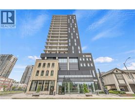 A tall building with a glass facade is the focal point of the image.
