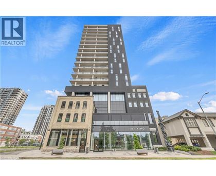 A tall building with a glass facade is the focal point of the image.