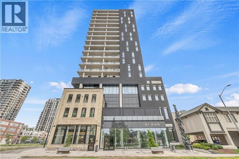 A tall building with a glass facade is the focal point of the image.