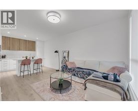 A well-lit bedroom with a bed, a couch, and a dining area.