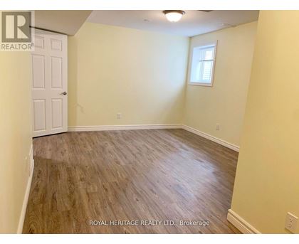 A room with wooden flooring and a white door.