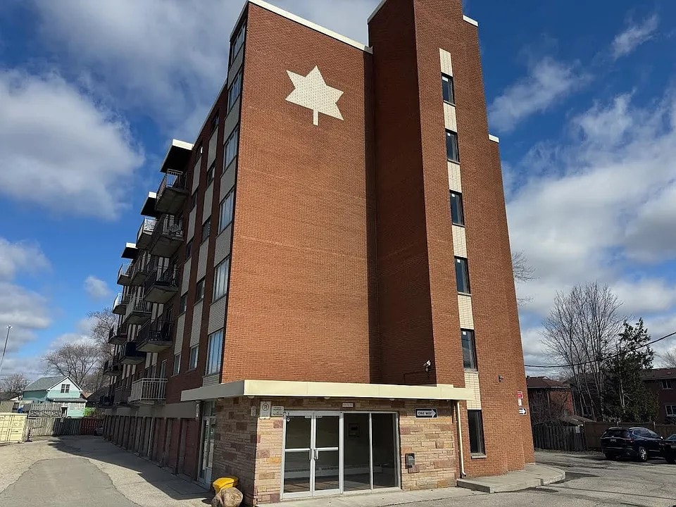 A large red brick building with a white star on the side.