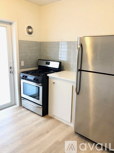 A kitchen with a stove, oven, and refrigerator.