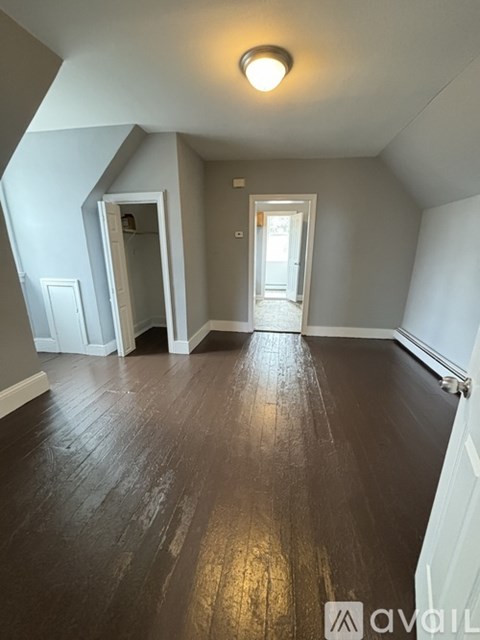 A room with wooden floors and white walls.