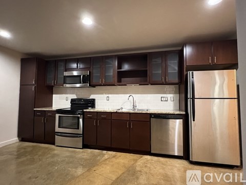 A kitchen with brown cabinets and stainless steel appliances.