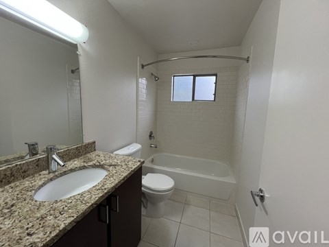 A bathroom with a sink, toilet, and bathtub.