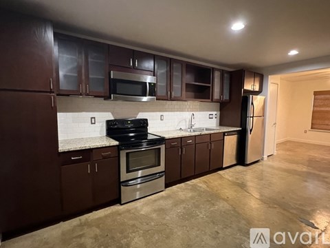 A kitchen with brown cabinets and stainless steel appliances.