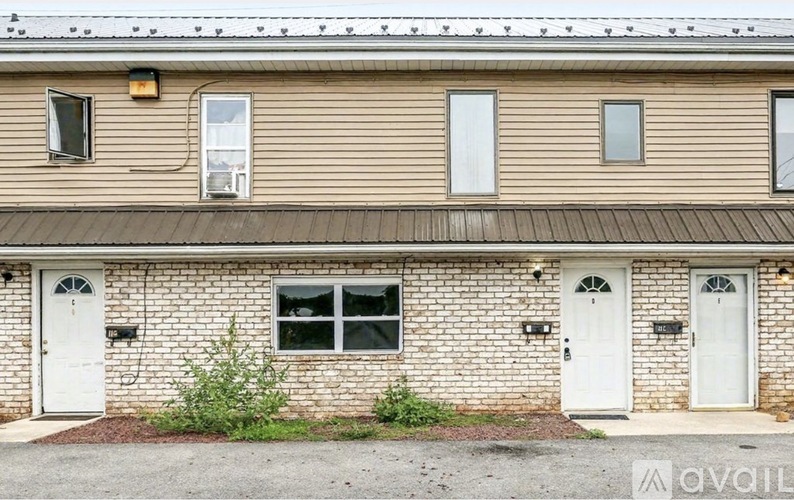 A building with a beige siding and white doors.