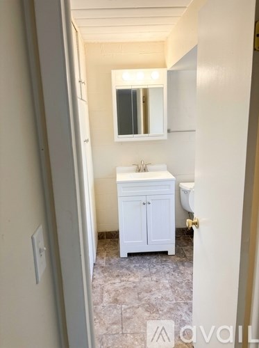A bathroom with a sink, toilet and medicine cabinet.