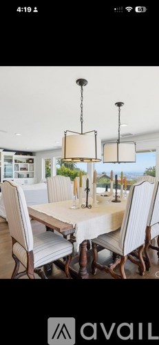 A dining room with a table and chairs.