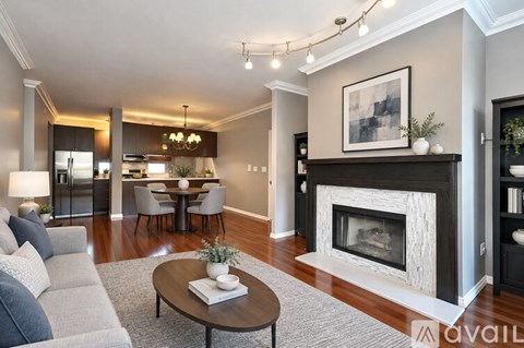 A modern living room with a fireplace and a dining area.