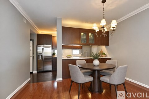 A modern kitchen with a dining table and chairs.