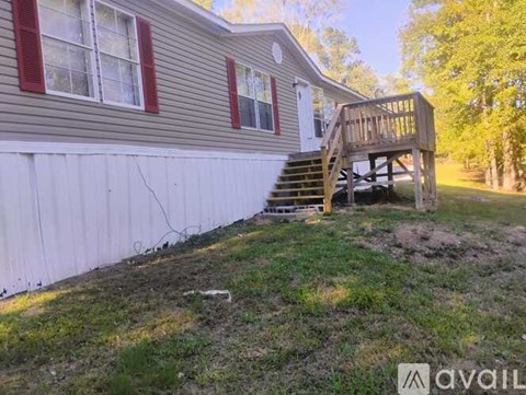 A house with a deck and a carport.