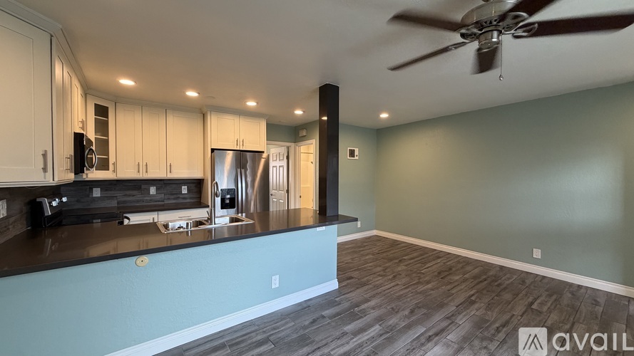 A modern kitchen with a fan on the ceiling.