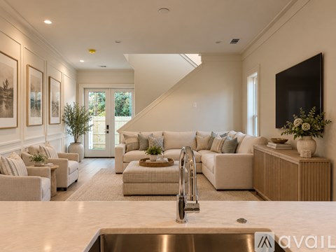 A modern living room with a staircase leading to the upper floor.