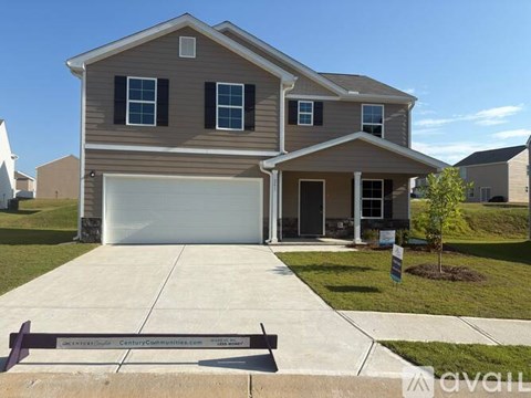 A two-story house with a garage is for sale.