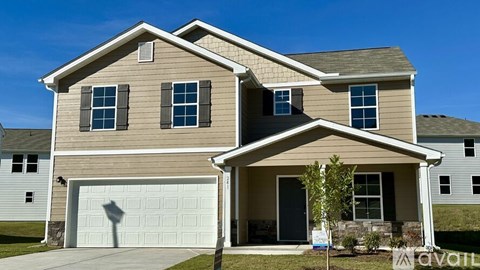 A two-story house with a garage is for sale.