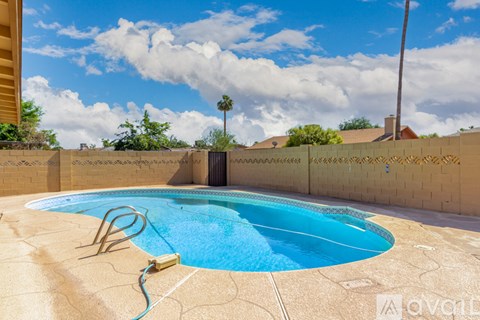 A small pool with a blue hose attached to it.