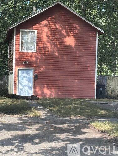 A red house with a blue door and a window.