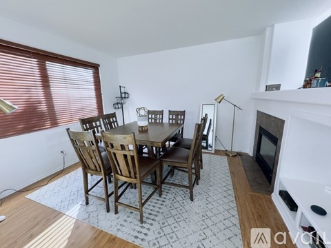 A dining room with a table and chairs.