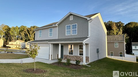 A house with a grey and yellow exterior is available for sale.
