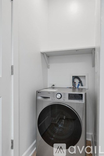 A washing machine is in a small space.