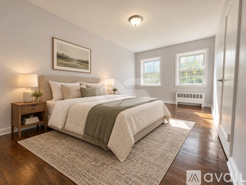 A bedroom with a large bed and a window.