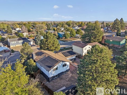 A bird's eye view of a residential area with houses and trees.