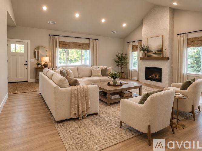 A living room with a white sofa, a coffee table, and a fireplace.