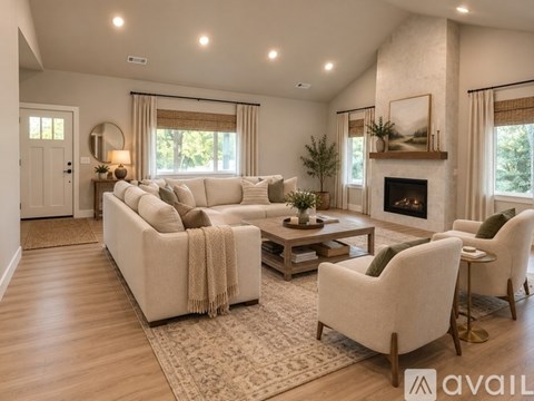 A living room with a white sofa, a coffee table, and a fireplace.