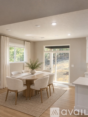A dining room with a table set for four.