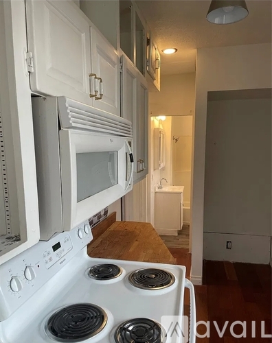 A kitchen with white appliances and cabinets.