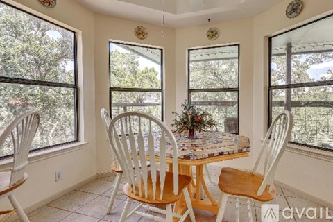 A dining room with a table and chairs.